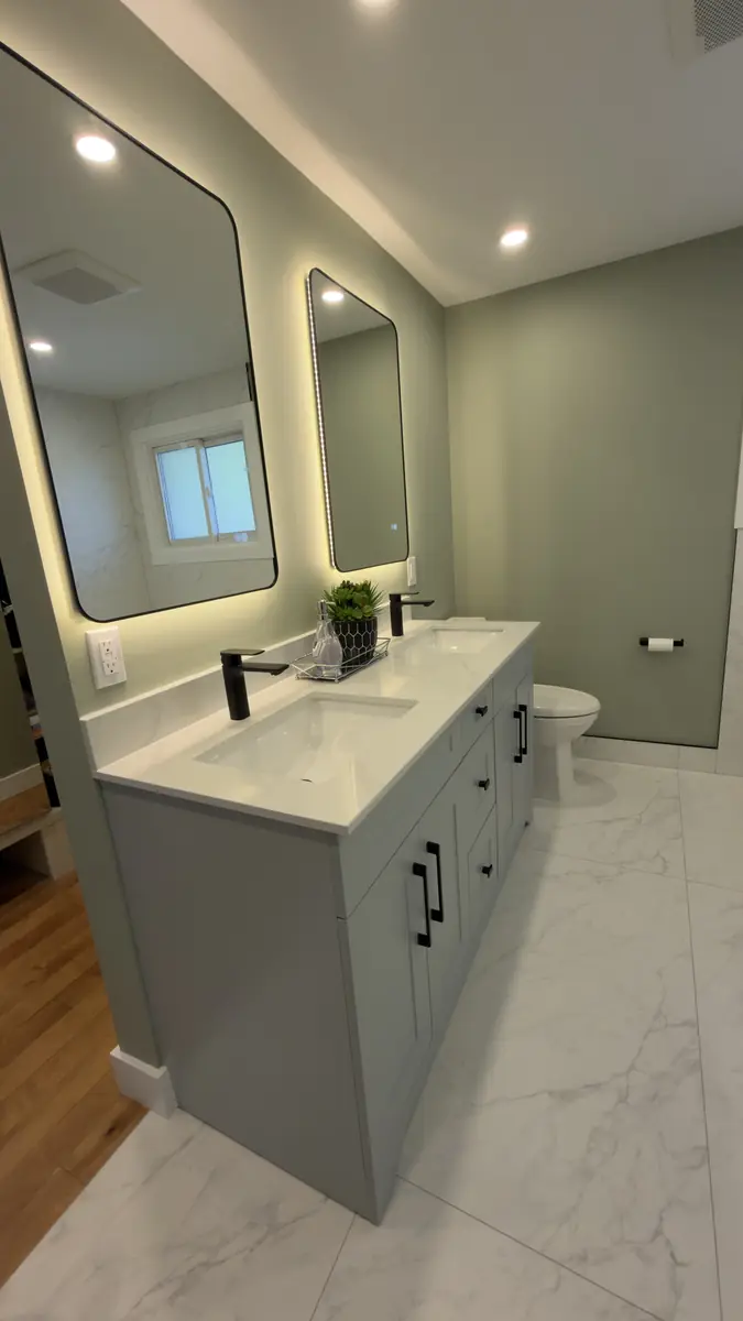 Grey shaker double vanity with black hardware and twin backlit LED mirrors