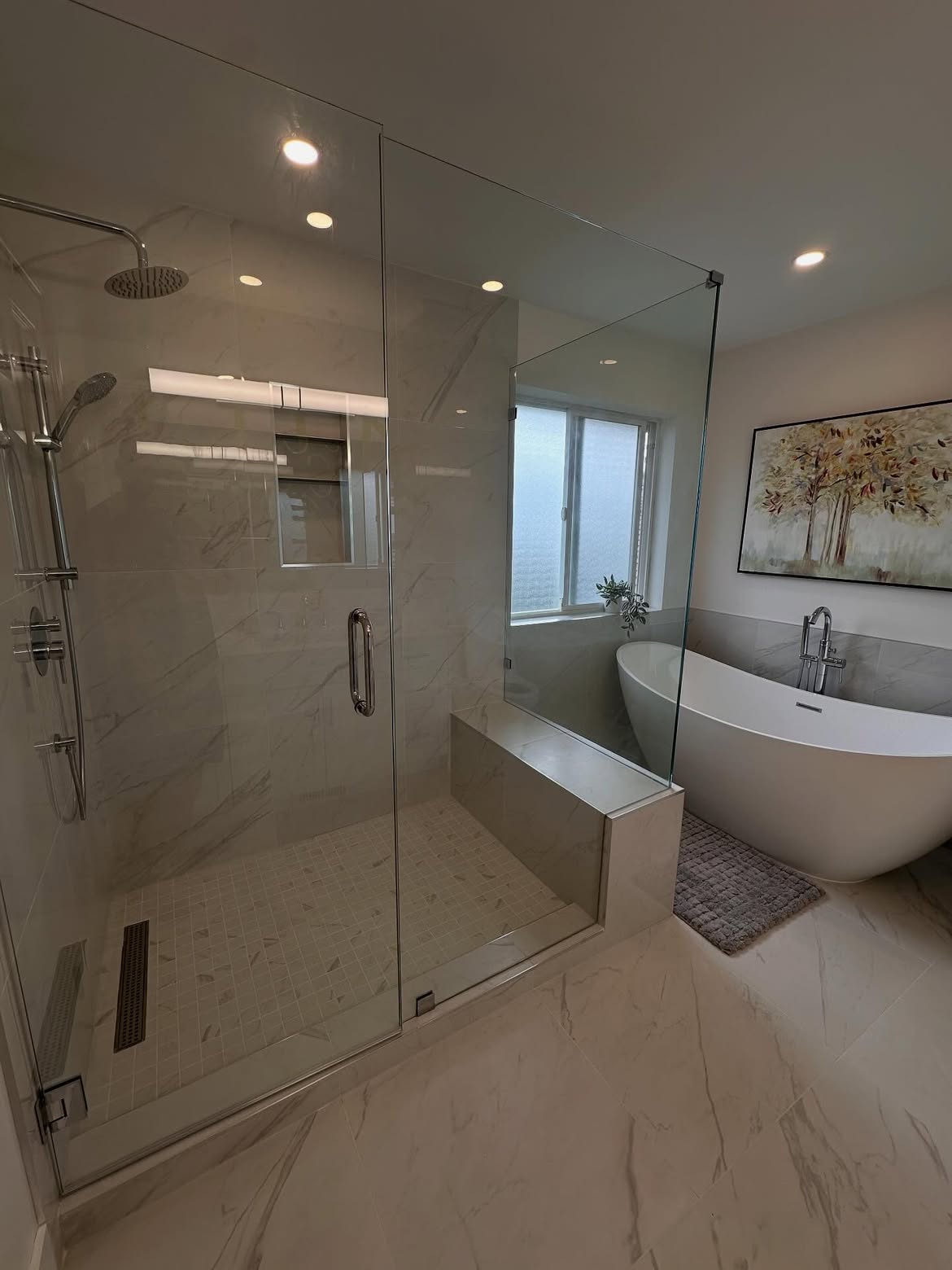 Corner jetted tub replaced with a marble walk-in shower and freestanding tub — after