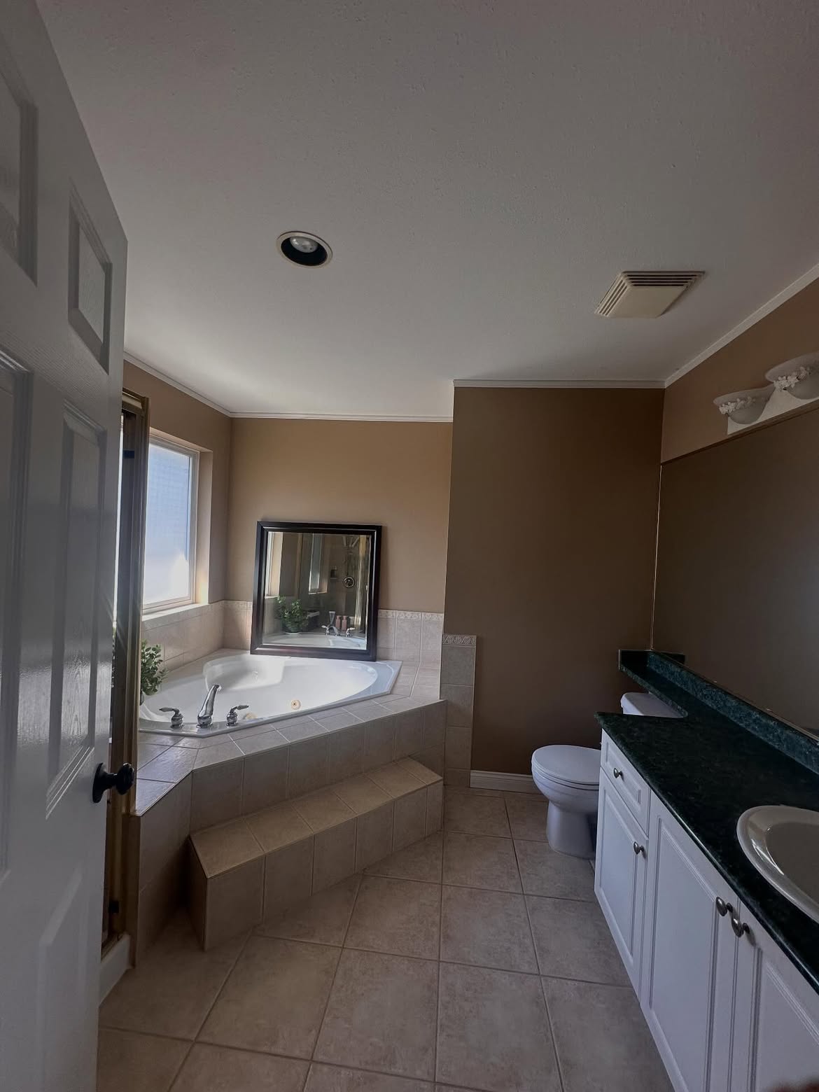 Corner jetted tub replaced with a marble walk-in shower and freestanding tub — before